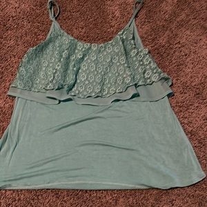 Cute turquoise tang top with adjustable straps.